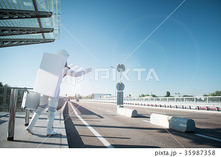 Man from space standing near road 35987358