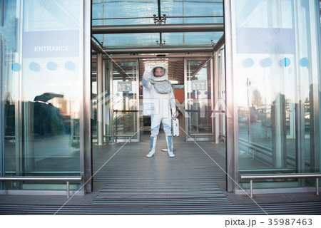 Spaceman standing afore open gates 35987463