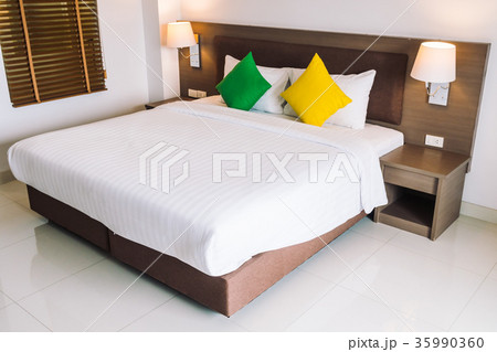Comfort pillow on bed decoration interior Comfort pillow on bed decoration interior 35990360