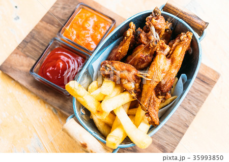 Fried chicken wing with french fries 35993850