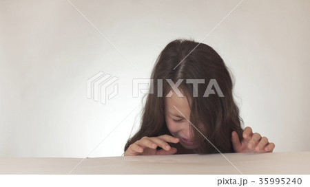 Beautiful sad teenage girl is crying on white Beautiful sad teenage girl is crying on white 35995240