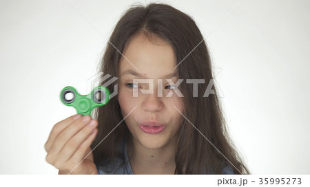 Beautiful cheerful teen girl playing with green Beautiful cheerful teen girl playing with green 35995273
