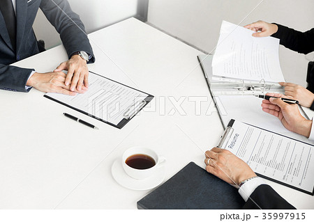 Businessman conducting an interview with businessman in an offic Businessman conducting an interview with businessman in an offic 35997915