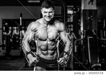 Attractive model young man training in gym 36000558