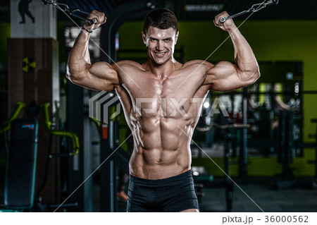 Attractive model young man training in gym 36000562