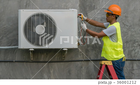 Technician is checking air conditioner Technician is checking air conditioner 36001212