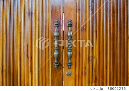 Brass handles of wooden door 36001256