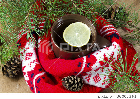 Hot winter tea and Christmas red scarf. 36003361