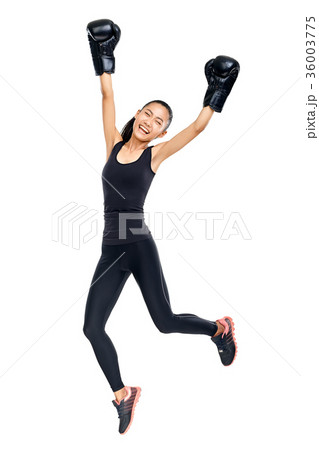 Asian woman in boxing gloves jumping in triumph of victory Asian woman in boxing gloves jumping in triumph of victory 36003775