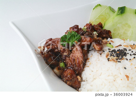 Chicken with rice and vegetables in background 36003924