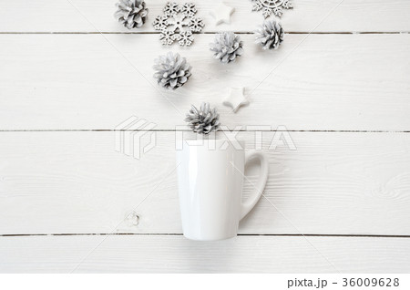 Mockup white cup with christmas cones and stars 36009628