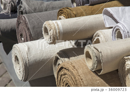 Rolls of linen canvas textile on market stall 36009723