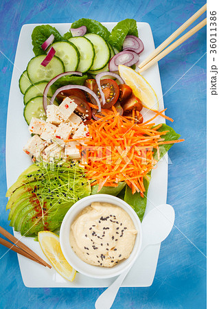 Rectangular rainbow vegan plate with vegetables Rectangular rainbow vegan plate with vegetables 36011386