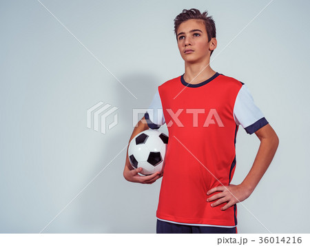Photo of teen boy in sportswear holding soccer ball 36014216