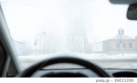 Bad weather driving in winter. Fog on the road 36015200