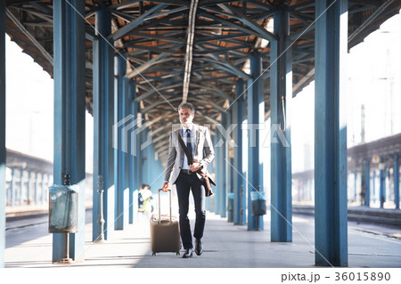 Mature businessman on a train station. Mature businessman on a train station. 36015890