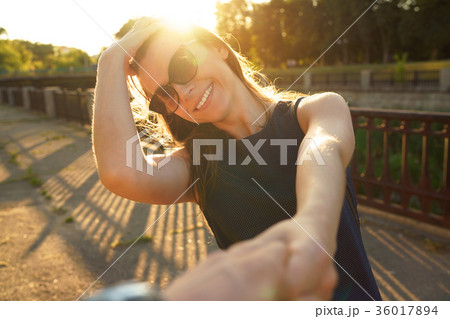 Follow me - happy young woman pulling guy's hand 36017894