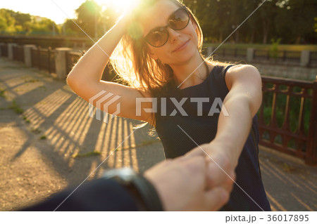 Follow me - happy young woman pulling guy's hand Follow me - happy young woman pulling guy's hand 36017895