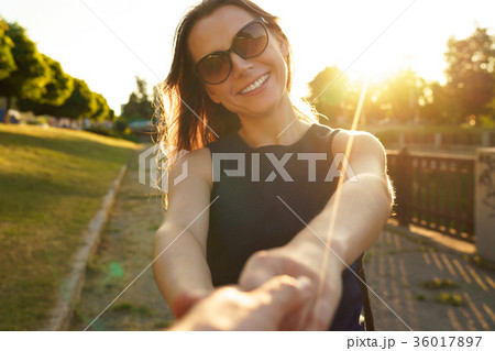Follow me - happy young woman pulling guy's hand 36017897