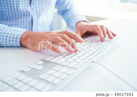 Men office worker typing on the keyboard Men office worker typing on the keyboard 36017933