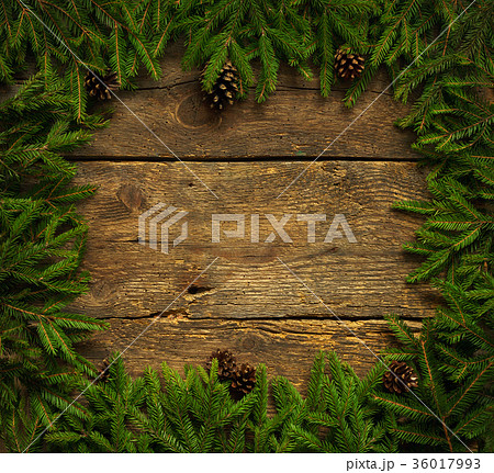 Christmas tree branches with cones on wood texture Christmas tree branches with cones on wood texture 36017993