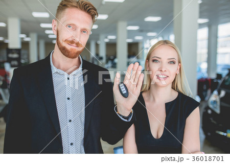 Beautiful couple is holding a key of their new car Beautiful couple is holding a key of their new car 36018701