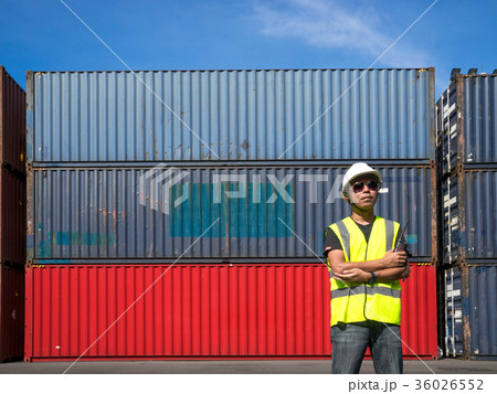Foreman standing front Containers box from Cargo freight ship fo Foreman standing front Containers box from Cargo freight ship fo 36026552