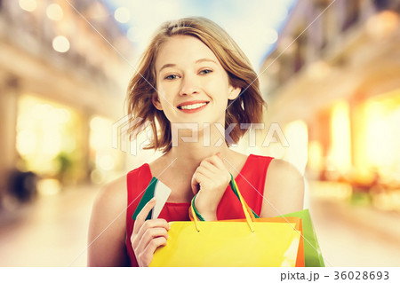 Happy young woman holding shopping bags Happy young woman holding shopping bags 36028693