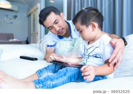 Father and son are using tablet in spending time Father and son are using tablet in spending time 36032020