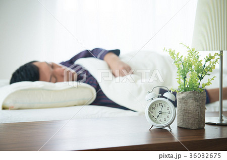 ぐっすり寝る若い男性　目覚まし時計 36032675