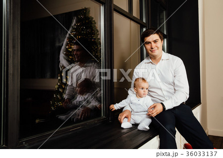 Happy father with his one year old son playing at 36033137