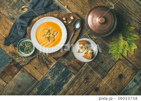 Fall pumpkin cream soup with croutons and seeds 36033738
