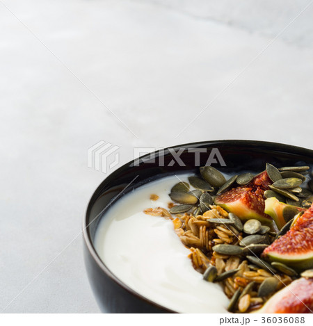Healthy breakfast yogurt bowl with granola and fig Healthy breakfast yogurt bowl with granola and fig 36036088
