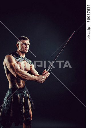 Severe barbarian in leather costume with sword Severe barbarian in leather costume with sword 36037635