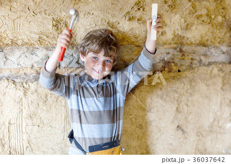 Little kid boy helping with toy tools on Little kid boy helping with toy tools on 36037642