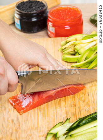 the chef cuts red fish with a knife the chef cuts red fish with a knife 36038415
