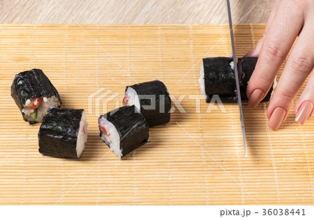 Chef cuts rolls, hands close-up 36038441