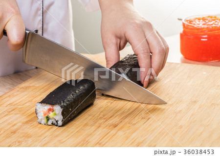 Chef cuts rolls, hands close-up Chef cuts rolls, hands close-up 36038453