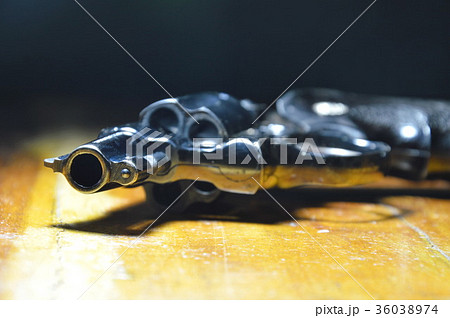 revolver gun on wooden table revolver gun on wooden table 36038974