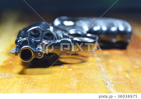 revolver gun on wooden table revolver gun on wooden table 36038975