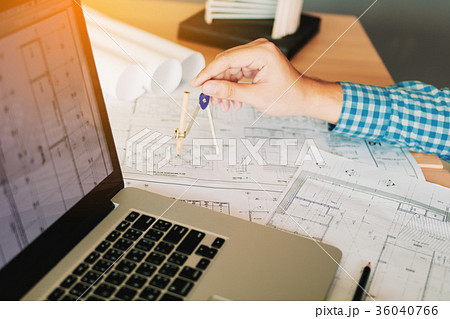 Architect working on blueprint in workplace 36040766