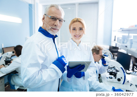 Smiling biologists discussing gene research Smiling biologists discussing gene research 36042977