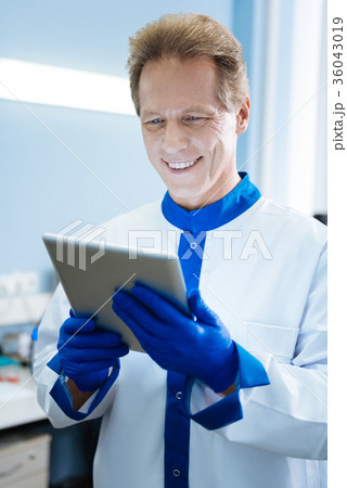Smiling young scientist holding a tablet 36043019