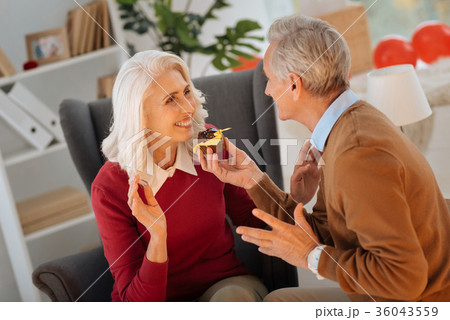 Romantic elderly couple tasting chocolate cupcake Romantic elderly couple tasting chocolate cupcake 36043559