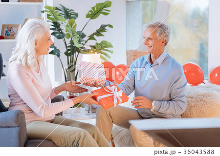 Mindful husband and wife exchanging gifts Mindful husband and wife exchanging gifts 36043588