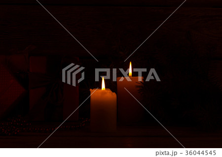Christmas candle on a dark background. 36044545