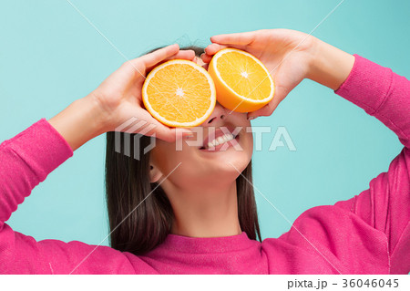 Beautiful woman's face with juicy orange 36046045