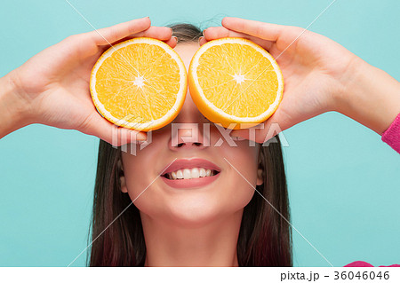 Beautiful woman's face with juicy orange 36046046