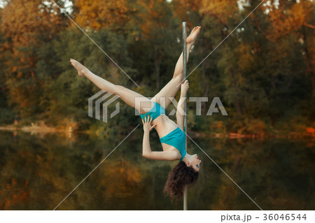 Girl does tricks on a pole dance. 36046544