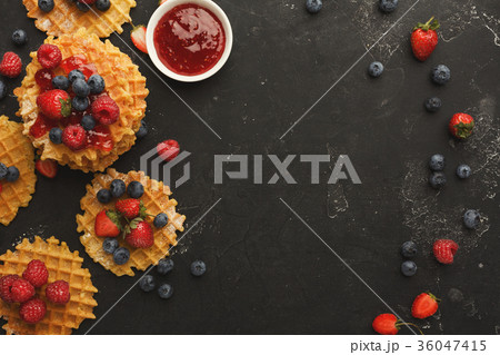 Round belgium waffles with berries Round belgium waffles with berries 36047415